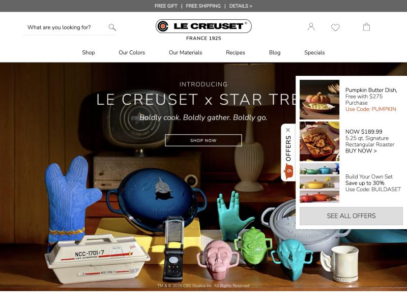 Le Creuset site with a vertical "Offers" tab fixed to the right edge, expanded into a panel listing a free-gift offer, a discounted roaster and a build-your-own-set discount code